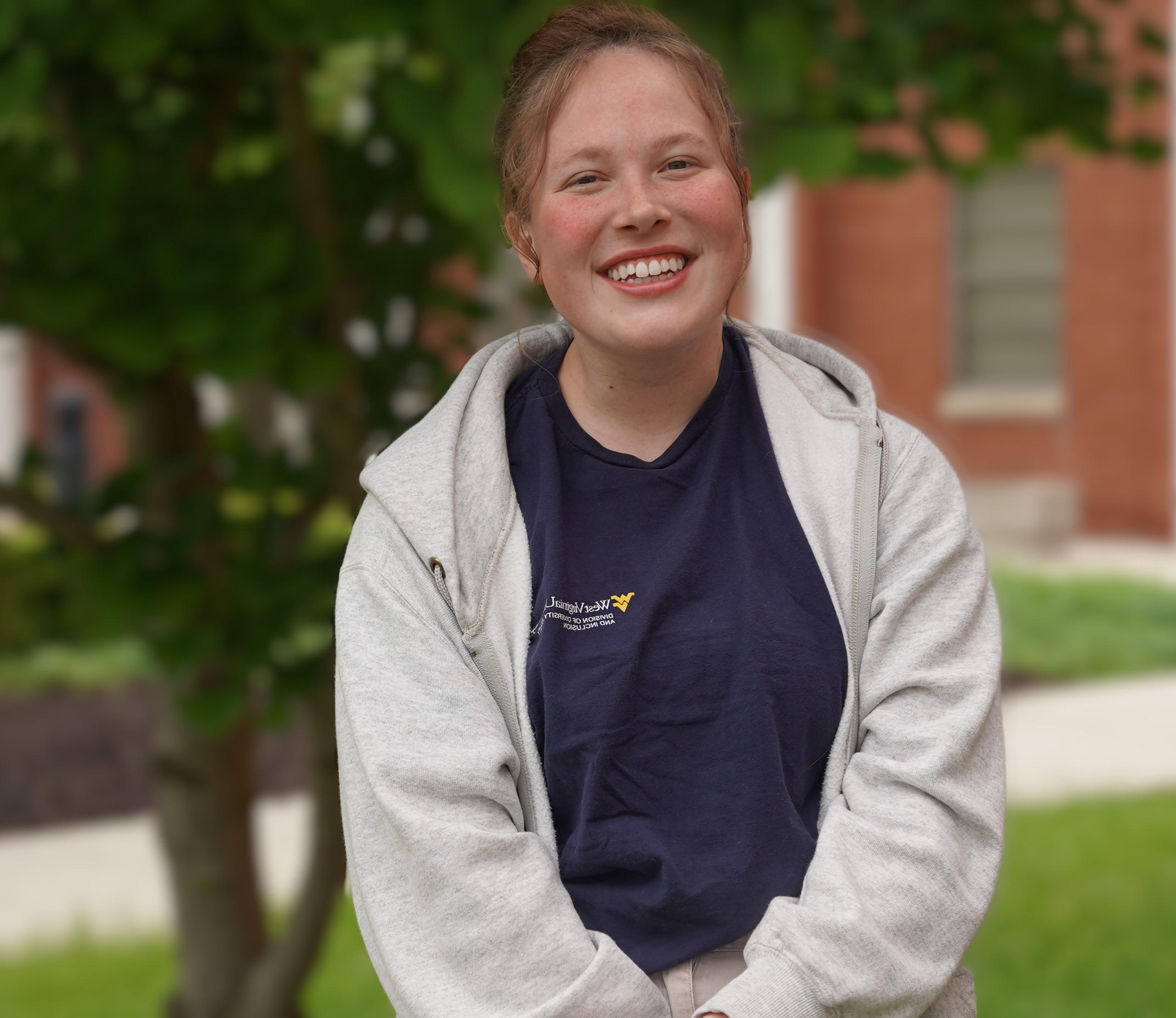 a portrait of Emma Craddock, smiling and posing for the camera